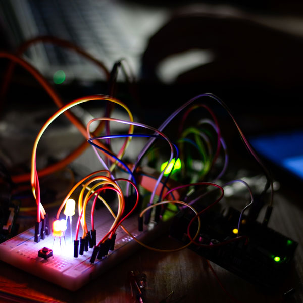 electrical wiring lit up in a dark room