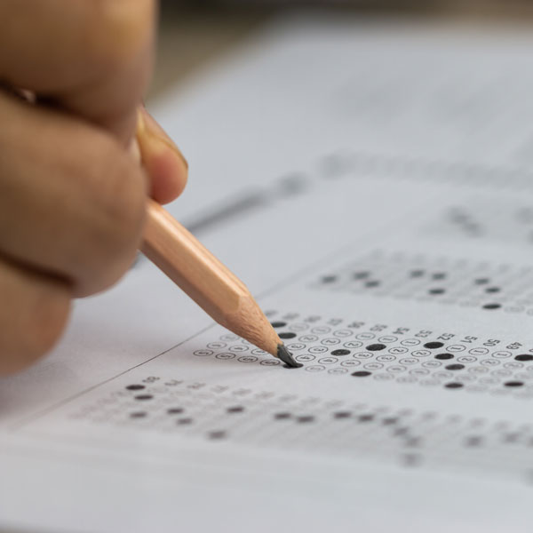 close up of student filling out bubbles on exam sheet