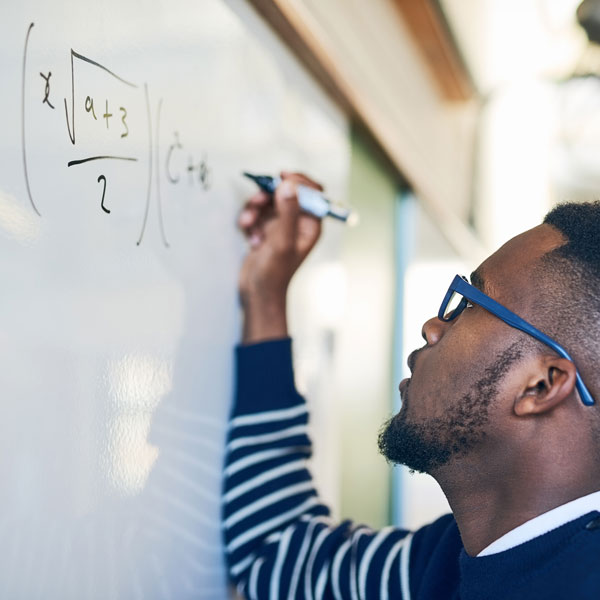 electrician student doing math on whiteboard