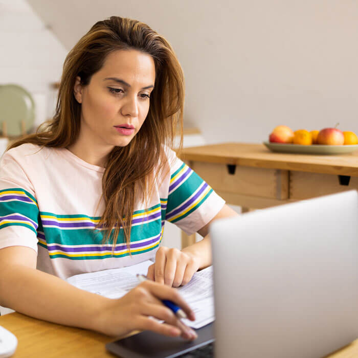 adult woman working at home on a self-paced program to become an electrician
