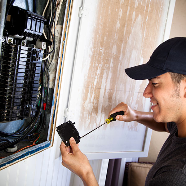 A man fixing an electrical outlet